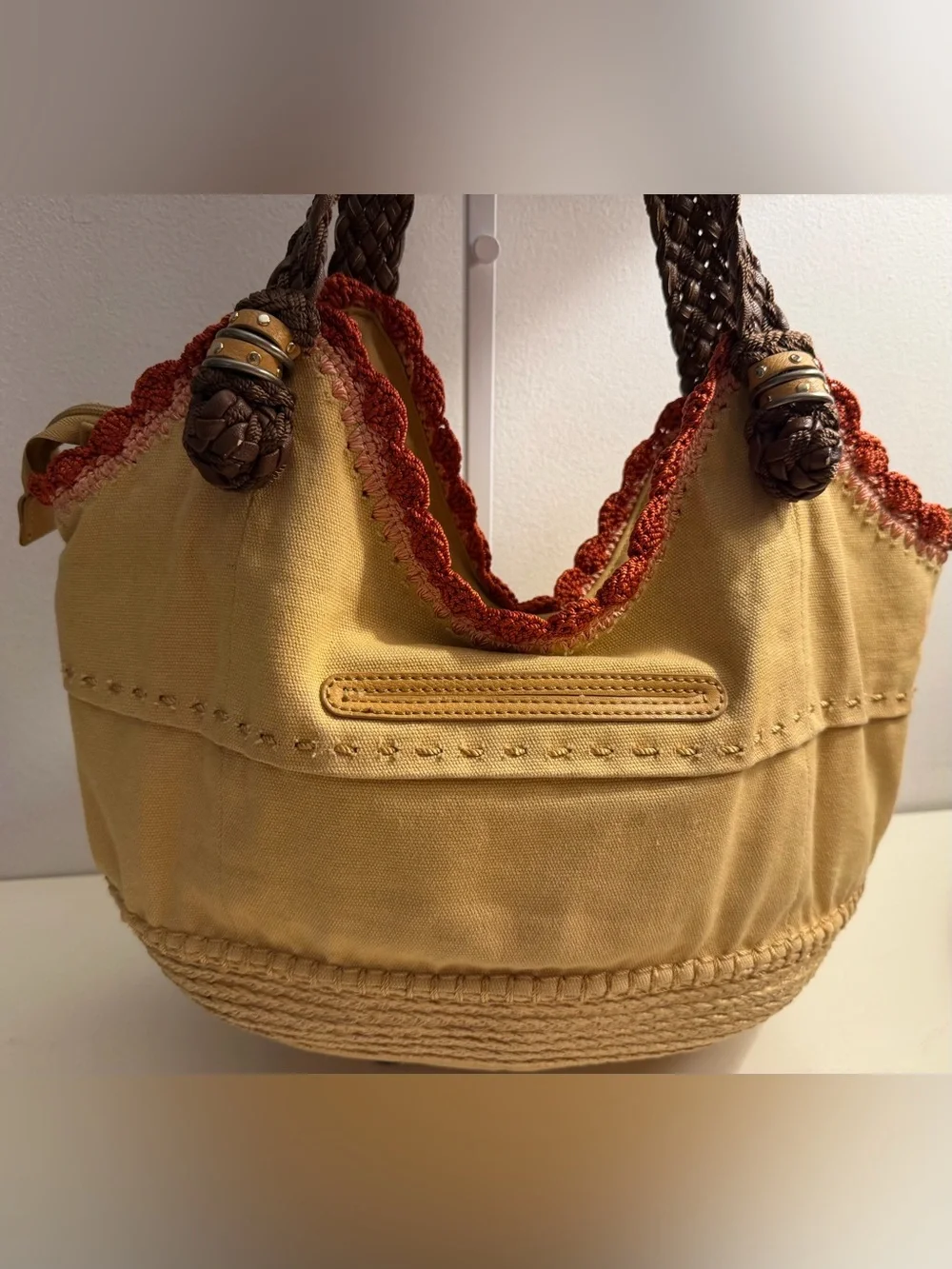 The Sak tan canvas Indio hobo bag with braided brown straps and crochet trim